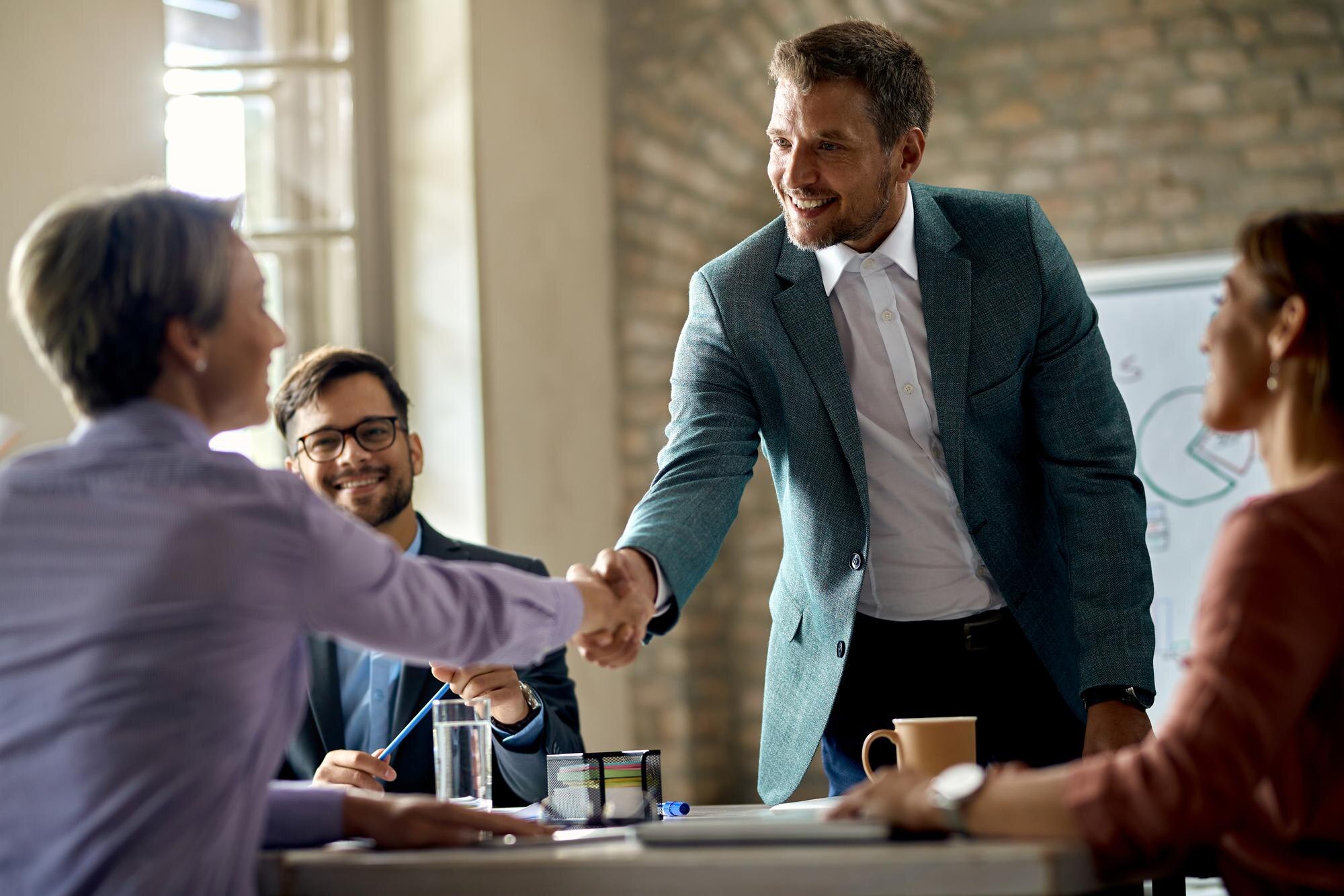 business-coworkers-shaking-hands-meeting-office-focus-is-businessman_637285-7009